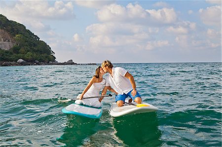 surfing - Dressed up man and woman riding paddle boards Foto de stock - Sin royalties Premium, Código: 673-06964468