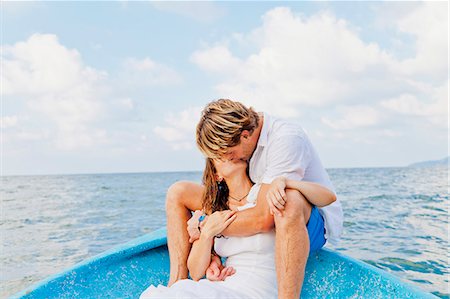 small boat - Man and woman embracing in bow of boat Stock Photo - Premium Royalty-Free, Code: 673-06964478