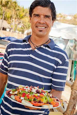 Man holding platter of mexican food Stock Photo - Premium Royalty-Free, Code: 673-06964596