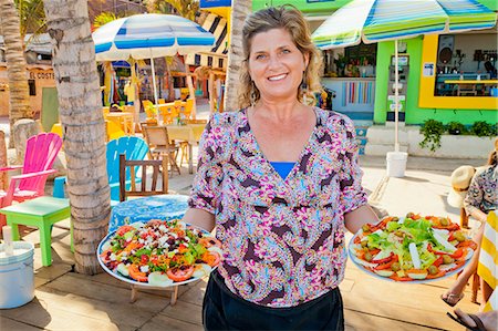 restaurants patio furniture - Woman holding plates of mexican food Stock Photo - Premium Royalty-Free, Code: 673-06964602