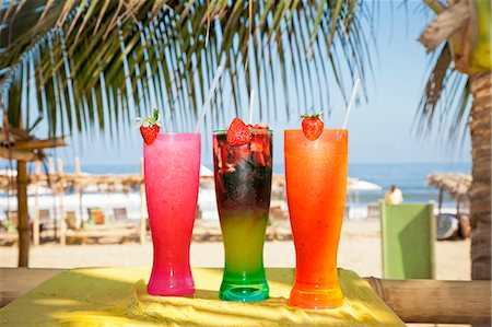 Row of colorful drinks on seaside table Stock Photo - Premium Royalty-Free, Code: 673-06964612