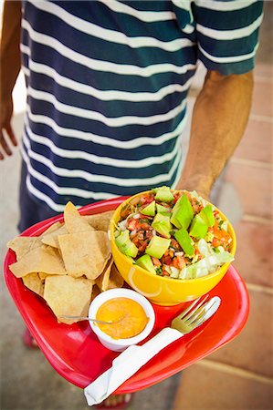 simsearch:853-03616777,k - Man holding plate of mexican food Stock Photo - Premium Royalty-Free, Code: 673-06964624