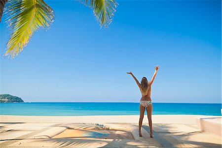 palm woman beach - Woman in bikini jumping on beach Stock Photo - Premium Royalty-Free, Code: 673-06964730