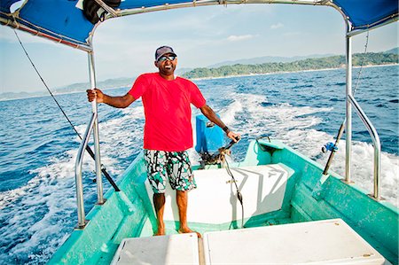 Man running fishing charter boat Foto de stock - Sin royalties Premium, Código: 673-06964756