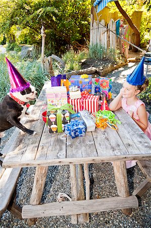 dog in a present box - Young girl and dog at outdoor birthday paty Stock Photo - Premium Royalty-Free, Code: 673-06964864