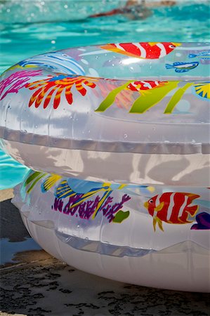 plastic toys - Float rings next to swimming pool Stock Photo - Premium Royalty-Free, Code: 673-06964874