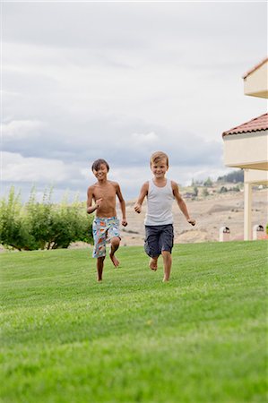 friends playing at home - Two boys running on grass Stock Photo - Premium Royalty-Free, Code: 673-08139227