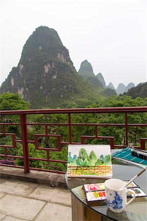 paintings of paint brush in water - Watercolor materials on a patio overlooking the Karst  mountains, Yangshuo, China Stock Photo - Premium Royalty-Free, Code: 673-08139284