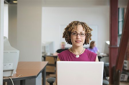 A young woman working at her desk in a loft-style office. Stock Photo - Premium Royalty-Free, Code: 673-02137570