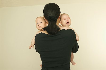 sad asian child - A mother holding her twin babies. Stock Photo - Premium Royalty-Free, Code: 673-02137608