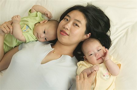 poses indoor multigeneration family portrait - High angle portrait of a mom with her twin babies. Stock Photo - Premium Royalty-Free, Code: 673-02137609