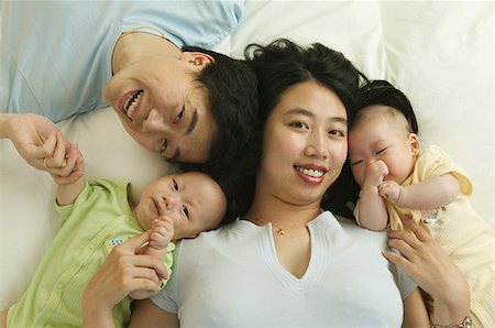 foursome - High angle portrait of a man and woman with their twin babies. Stock Photo - Premium Royalty-Free, Code: 673-02137610