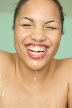 face and cleanse and on person - Close-up of a woman with a wet face. Stock Photo - Premium Royalty-Free, Code: 673-02137659