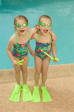 fins - Twin girls standing poolside. Stock Photo - Premium Royalty-Free, Code: 673-02137897