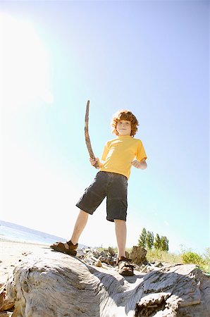 Young, red-headed boy holding a stick. Stock Photo - Premium Royalty-Free, Code: 673-02137913