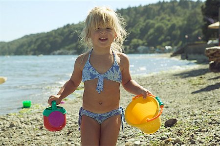 seasonal lake - Young girl holding beach toys. Stock Photo - Premium Royalty-Free, Code: 673-02137927