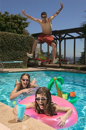 Teenagers playing in a swimming pool. Stock Photo - Premium Royalty-Free, Code: 673-02137971