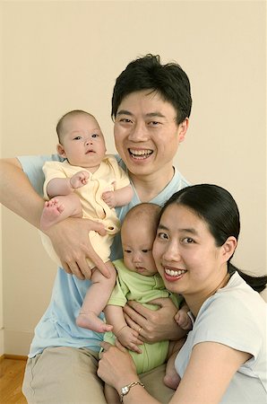 A couple embracing their twin babies. Stock Photo - Premium Royalty-Free, Code: 673-02138034