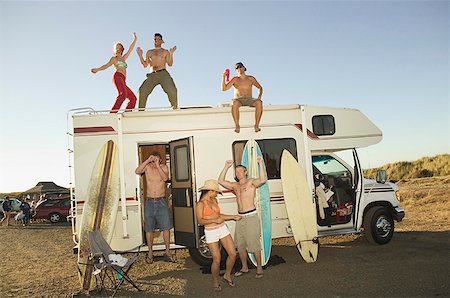 swimsuit party - Young people dancing on and around a motor home. Stock Photo - Premium Royalty-Free, Code: 673-02138097