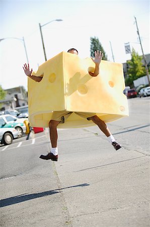 Man in a cheese costume leaping in the air. Stock Photo - Premium Royalty-Free, Code: 673-02138159