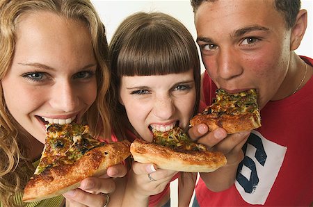 Three teenagers eating pizza. Stock Photo - Premium Royalty-Free, Code: 673-02138187