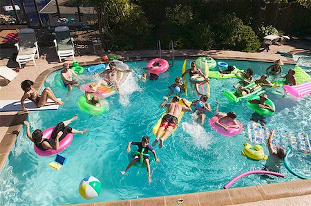 swimming in the pool with girl and man - Overhead view of a pool party. Stock Photo - Premium Royalty-Free, Code: 673-02138227