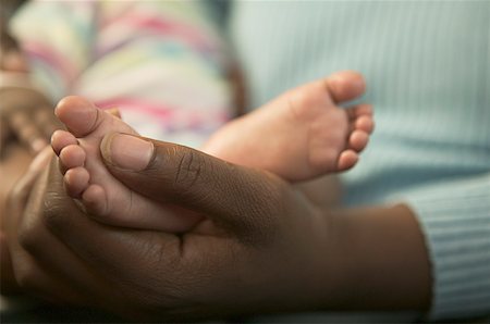 fingering mom photo - A mother holding her baby daughter's feet. Stock Photo - Premium Royalty-Free, Code: 673-02138344