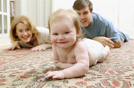 dad crawling - A baby crawling on the floor. Stock Photo - Premium Royalty-Free, Code: 673-02138356