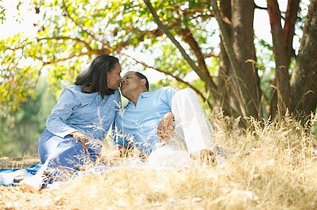 Senior couple cuddling in a park. Stock Photo - Premium Royalty-Free, Code: 673-02138429