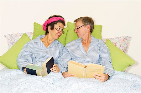 double bedroom - A couple reading together in bed and wearing matching pajamas. Stock Photo - Premium Royalty-Free, Code: 673-02138439