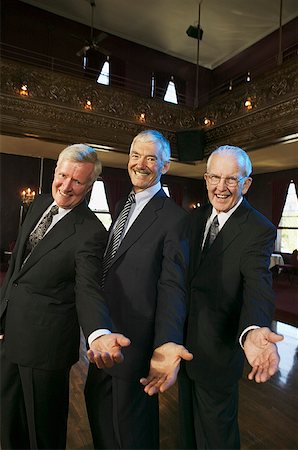 Three senior men holding out their hands on the dance floor. Stock Photo - Premium Royalty-Free, Code: 673-02138478