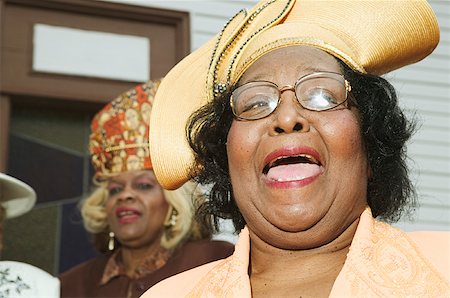 elderly person singing - Senior women wearing hats and singing on church steps. Stock Photo - Premium Royalty-Free, Code: 673-02138496