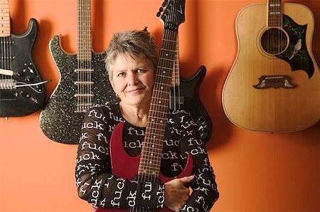 Portrait of a woman and her guitars. Stock Photo - Premium Royalty-Free, Code: 673-02138577