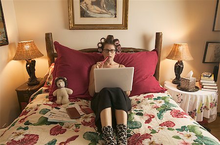 Woman in curlers working on personal finances. Stock Photo - Premium Royalty-Free, Code: 673-02138591