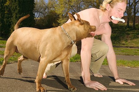 friends race - Young man about to race with a dog Stock Photo - Premium Royalty-Free, Code: 673-02138668