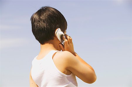 simsearch:673-02139120,k - A boy using a mobile phone Stock Photo - Premium Royalty-Free, Code: 673-02138720