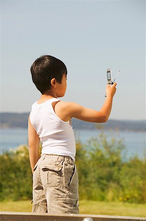 simsearch:673-02138722,k - Young boy taking a photo with his mobile phone Stock Photo - Premium Royalty-Free, Code: 673-02138722