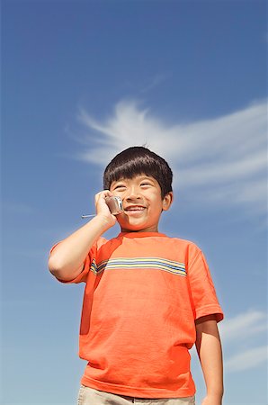 simsearch:673-02138722,k - Young boy using his mobile phone Stock Photo - Premium Royalty-Free, Code: 673-02138723