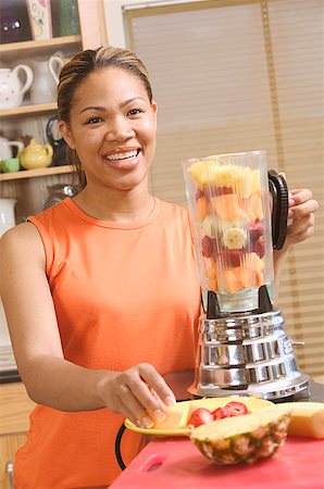 Woman making a blended fruit drink Stock Photo - Premium Royalty-Free, Code: 673-02138822