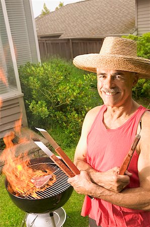 steak summer - A man grilling in his backyard Stock Photo - Premium Royalty-Free, Code: 673-02138892