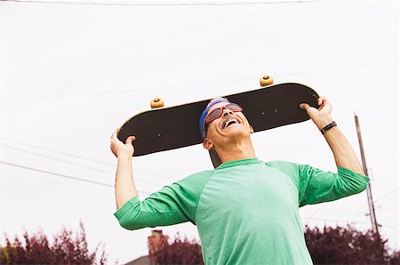 Middle-aged man with his skateboard Stock Photo - Premium Royalty-Free, Code: 673-02138932