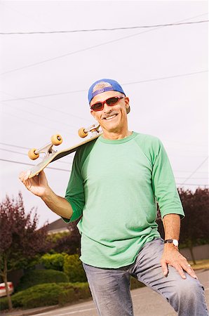 Middle-aged man with his skateboard Stock Photo - Premium Royalty-Free, Code: 673-02138933