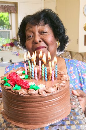 Woman holding a chocolate birthday cake Stock Photo - Premium Royalty-Free, Code: 673-02138971