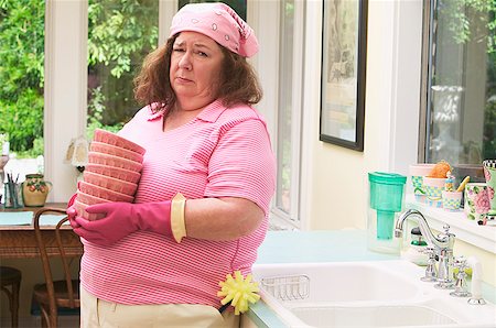 fat woman cleaning house - Woman unhappy about washing dishes Stock Photo - Premium Royalty-Free, Code: 673-02139066