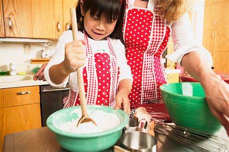 family working household together - A female adult and child cooking together Stock Photo - Premium Royalty-Free, Code: 673-02139079