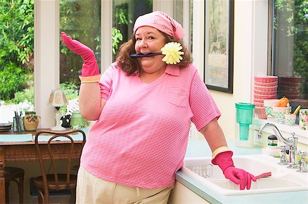 pink rubber gloves - A woman about to do the dishes Stock Photo - Premium Royalty-Free, Code: 673-02139099