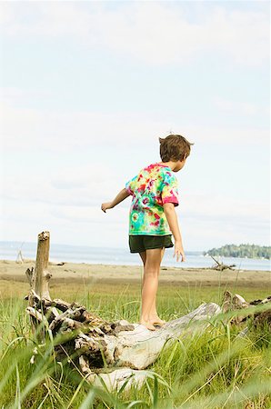 stabilization people - Boy walking on fallen log at the beach Stock Photo - Premium Royalty-Free, Code: 673-02139125