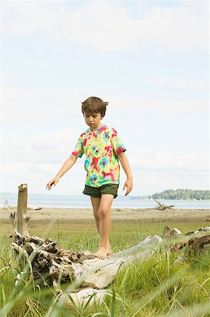 stabil - Boy walking on a log at the beach Stock Photo - Premium Royalty-Free, Code: 673-02139156