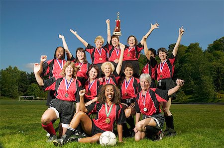 posing with trophy - Female soccer team celebrating Stock Photo - Premium Royalty-Free, Code: 673-02139183