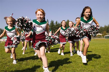 Cheerleaders running on an athletic field Stock Photo - Premium Royalty-Free, Code: 673-02139218